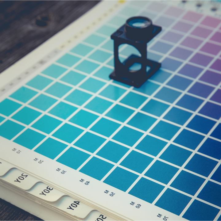 black magnifying lens on a book of colors